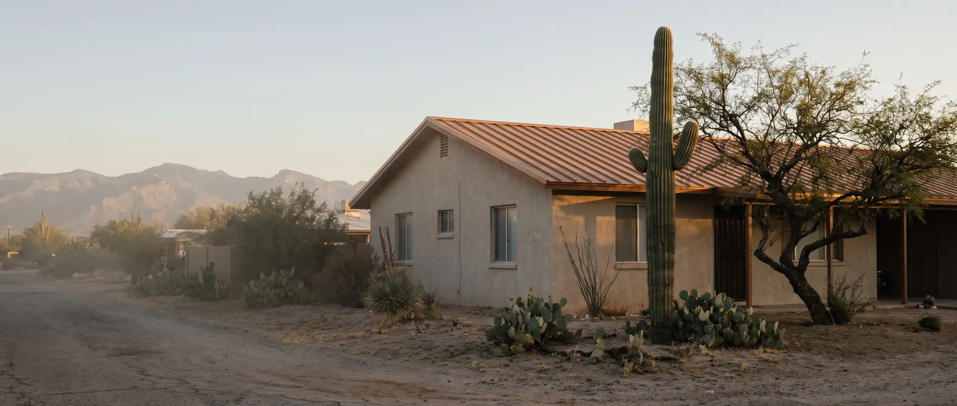 A finished metal roof on a Tucson home seen from the street in low morning light